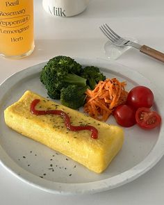 an omelet with ketchup, tomatoes and broccoli on a plate