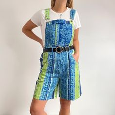 Funky, bright 80's short dungarees in blue and green striped, bandana style print. They have all the classic dungas detail, with pockets, strap clips and buttons on the sides. They are made from lightweight, denim-like cotton twill and are perfect for hot summer days, with trainers or sandals. Made by Antonia Bay. 100% cotton. Medium/Large size, labelled as size 16. Measurements when laid flat are: Waist: cm Hips: cm Inseam: cm Outer seam, up to waistline: Strap length can be adjusted. Excellent Blue Shortalls For Spring, Green Summer Shortalls Overalls, Vintage Blue Cotton Shortalls, Blue Vintage Cotton Shortalls, Blue Cotton Summer Overalls, Blue Short Summer Overalls, Blue Short Length Overalls For Summer, Blue Short-length Summer Overalls, Blue Short Length Summer Overalls