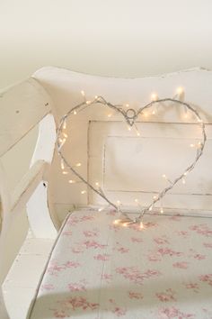 a white bench with a heart shaped light on it