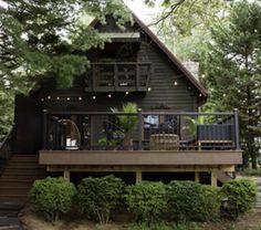 a house in the woods with stairs leading up to it