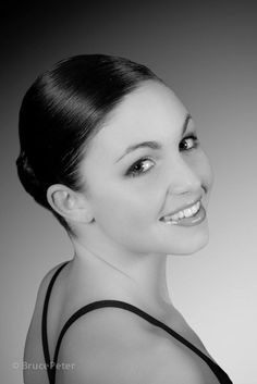 a black and white photo of a woman smiling