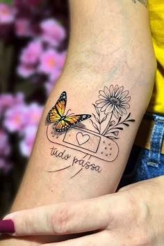 a woman's arm with a butterfly and flowers on it