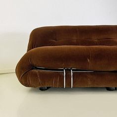 a brown couch sitting on top of a white floor