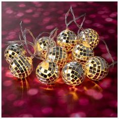 gold disco ball lights on a red and pink background