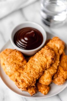 air fryer chicken tenders on a plate with dipping sauce