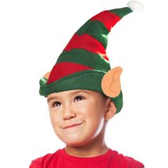 a young boy wearing a green and red elf hat