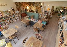 an overhead view of a restaurant with tables and chairs in front of bookshelves