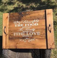 a wooden sign sitting on top of a grass covered field