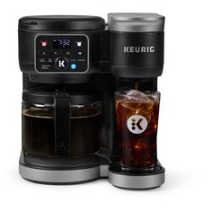 the keurig coffee maker is next to a glass with ice and soda in it