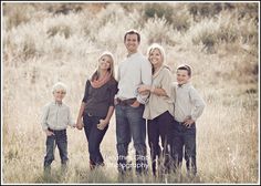 a family posing for a photo in a field