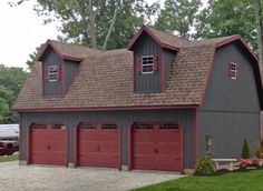 two story garage with red doors and windows