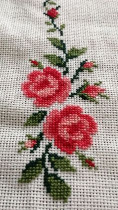 a cross stitch pattern with red roses on it