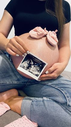 a pregnant woman is holding her baby bump