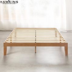 a wooden bed frame with no sheets on it