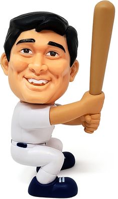 a bobble head baseball player holding a bat and smiling at the camera while sitting down