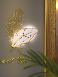 a clock that is on the side of a wall next to a palm leaf and words sweet hoi