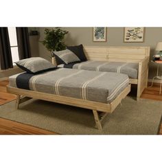 a bed sitting on top of a wooden frame