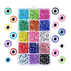 an assortment of colorful beads and eyeballs in a plastic case on a white background