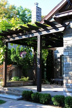 an outdoor patio with stone steps and pergolated roof