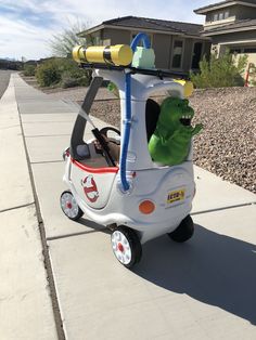 a toy car with a dinosaur riding on the front and back wheels that is attached to it's roof