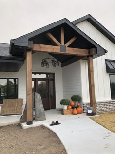 the front entrance to a home with pumpkins and other decorations