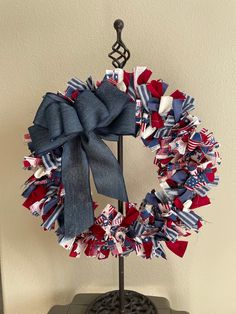 a patriotic wreath on top of a metal stand