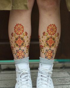 the legs and feet of a person with tattoos on them