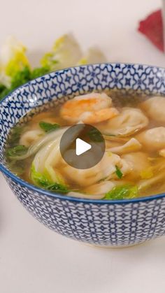 a blue and white bowl filled with soup