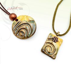 two pendants are sitting on a white surface, one is yellow and the other is brown