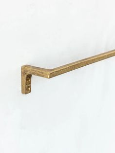 an old brass handle on a white wall