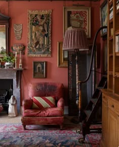 a living room filled with furniture and paintings on the wall