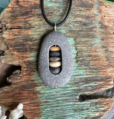 Beach stone with cairn stack of stones inside.  Beach stones found on the coast of Maine. Sterling silver jump ring is welded. Beach Stones Jewelry, Pebble Jewelry, Beach Pebbles, Jewelry Beach, Rock Jewelry, Beach Stones, Cairns, The Coast, Jump Rings