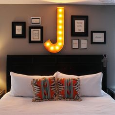 a bed with pillows and pictures on the wall