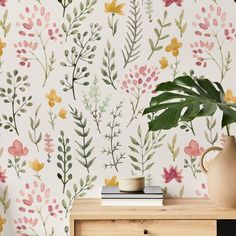 a wallpaper with flowers and leaves painted on it