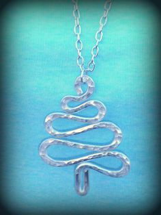 a silver necklace with a christmas tree on it