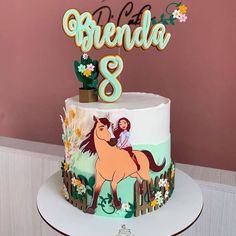 a birthday cake decorated with a horse and name