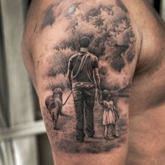 a man with a dog and child on his arm is holding the hand of another person