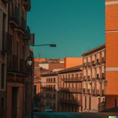 an empty city street with tall buildings on both sides and a traffic light in the distance