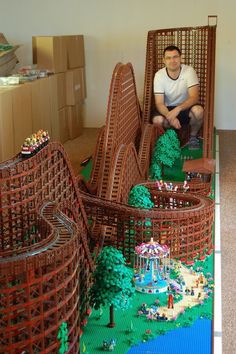 a man sitting in a chair made out of legos