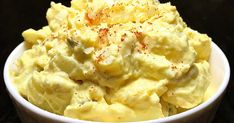 a white bowl filled with mashed potatoes on top of a table