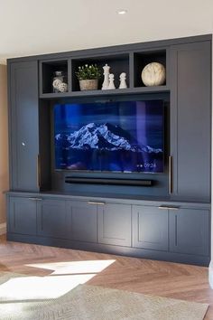 a large entertainment center with a flat screen tv mounted on it's side wall