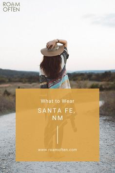 a woman standing on a dirt road with her back to the camera and text reading what to wear santa fe, nm