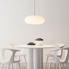 a white table with four chairs around it