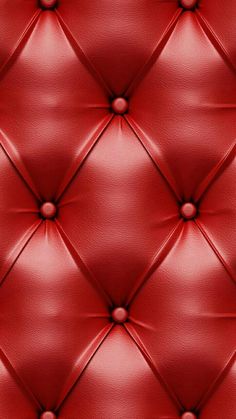 a red leather upholstered wall with buttons