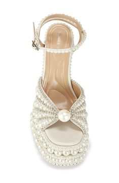 Varisized imitation pearls and glittering crystals imbue your ensemble with baroque beauty in this towering platform sandal encircled with a dainty ankle strap. 6" heel; 1 1/4" platform Adjustable ankle strap with buckle closure Water resistant Synthetic upper/leather lining/synthetic sole Imported Asian & Pacific Islander Owned/Founded Luxury Wedding Platform Sandals, White Platform Sandals With Ankle Strap, Azalea Wang Shoes, Azalea Wang Heels, Luxury Pearl-embellished Heels For Party, Fabric Gift Bags, Free Fabric, Fabric Gifts, Platform Sandals