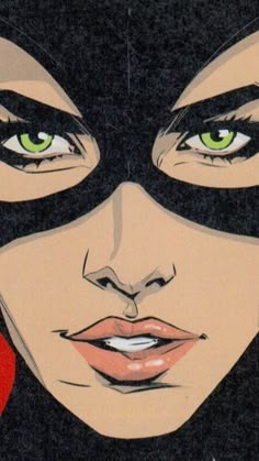 a woman with green eyes wearing a black mask