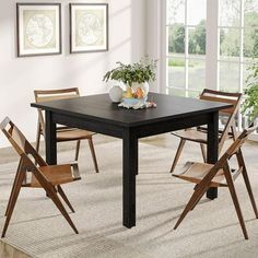 a dining room table with chairs and a potted plant on the top of it