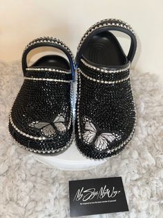 MyStyleMyWay's  custom crocs are designed for the perfect outfit, that special occasion, and "Just Because" you love blinged out crocs.  In the display shown we designed a pair of black classic crocs adding high quality colorful rhinestones. 🦋 Each Rhinestone is individually and neatly placed to achieve the design.  🦋Rhinestones are added to the top, side and the back trimming of the shoe. 🦋Burtterfly patches are applied to this design to add cuteness and personality.  🦋The sports mode strap Blinged Out Crocs, Customize Shoes, Bling Crocs, Bling Things, Custom Crocs, Classic Crocs, Shoe Makeover, Black Crocs, Crocs Fashion