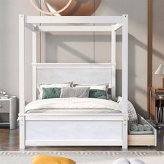 a white bed sitting in the middle of a bedroom