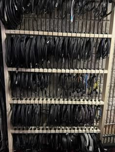 many wires and cables are stacked up on shelves